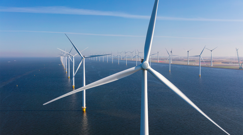 Offshore wind turbines in the sea on blue-sky day
