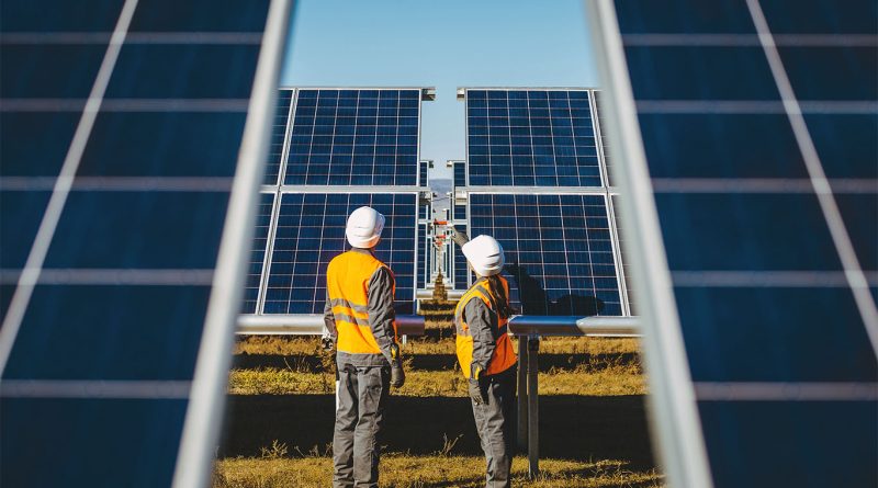 Wind turbines and solar panels generating renewable energy under a blue sky