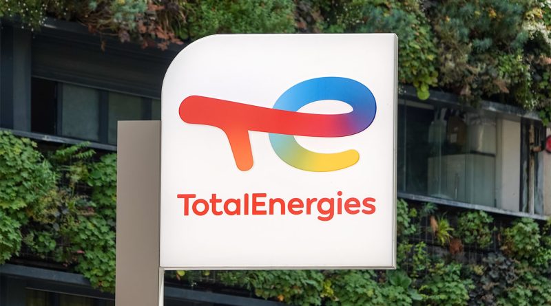 A TotalEnergies logo on a European power plant facility, symbolizing the company’s transition to renewable and flexible energy