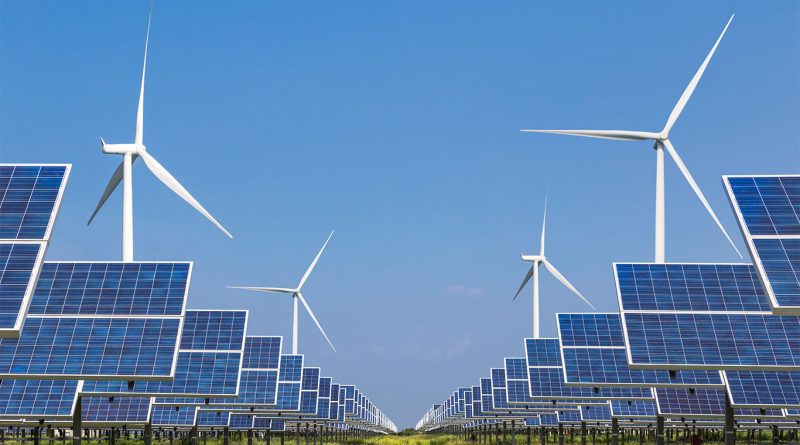 A wind farm and solar panels operating at sunset in 2025, symbolizing the global shift to renewable energy.